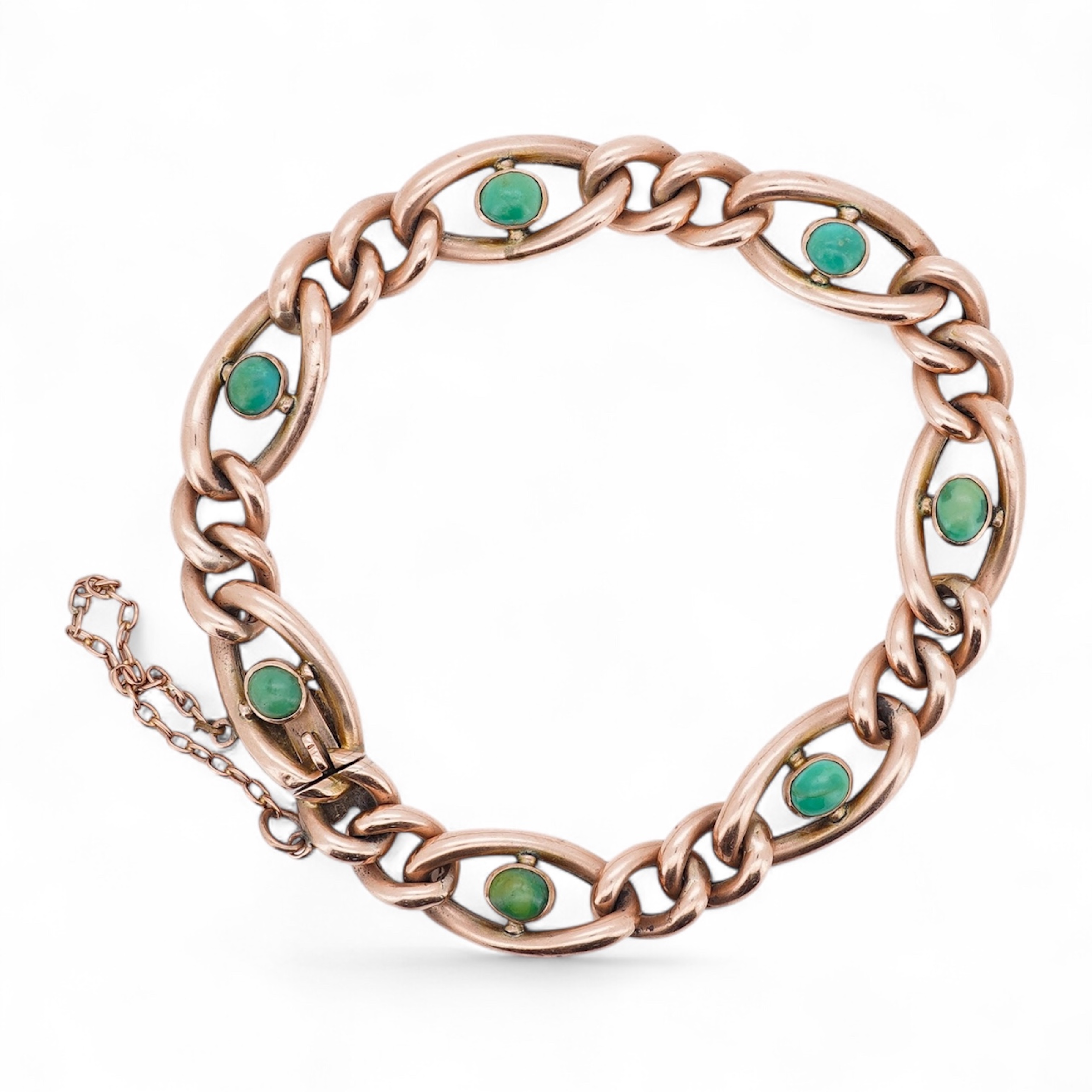 An early 20th century yellow metal (stamped 9c) and seven stone cabochon turquoise set curb link bracelet, 19cm, gross weight 14 grams. Condition - poor to fair